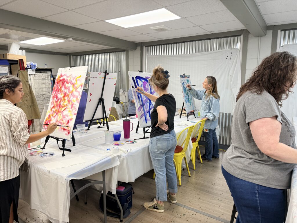 Students painting at easels during an intuitive painting workshop near Asheville